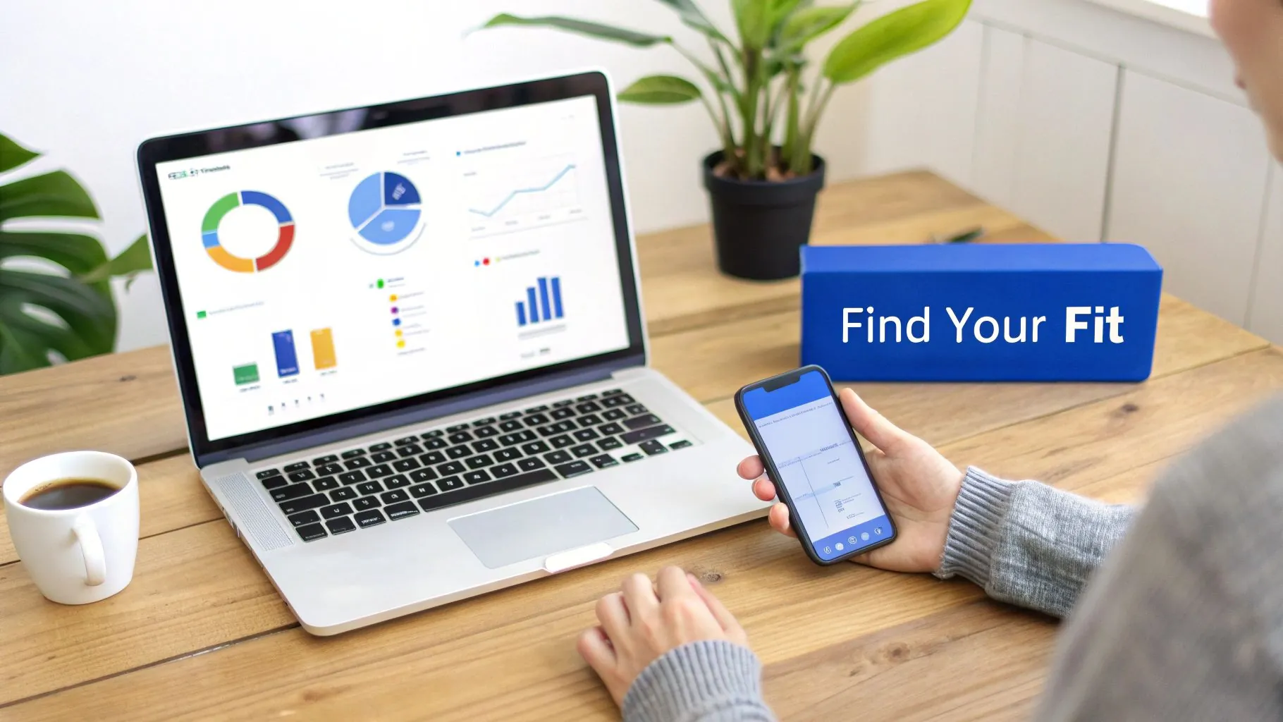 A person sitting at a desk and using their laptop to manage personal finances, with charts and graphs on the screen representing financial planning and budgeting.